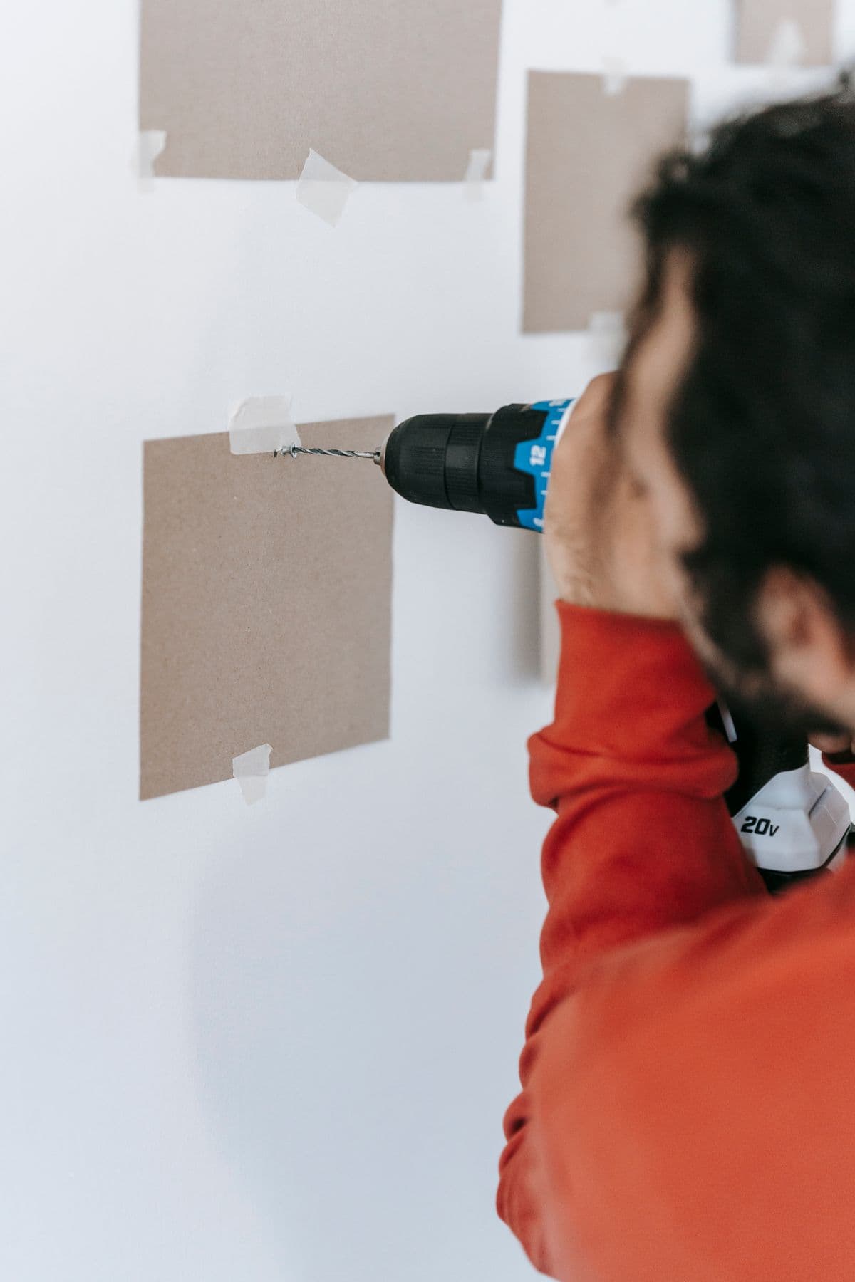 Tradesperson drilling into a wall — the kind of on-site detail our inspectors verify
